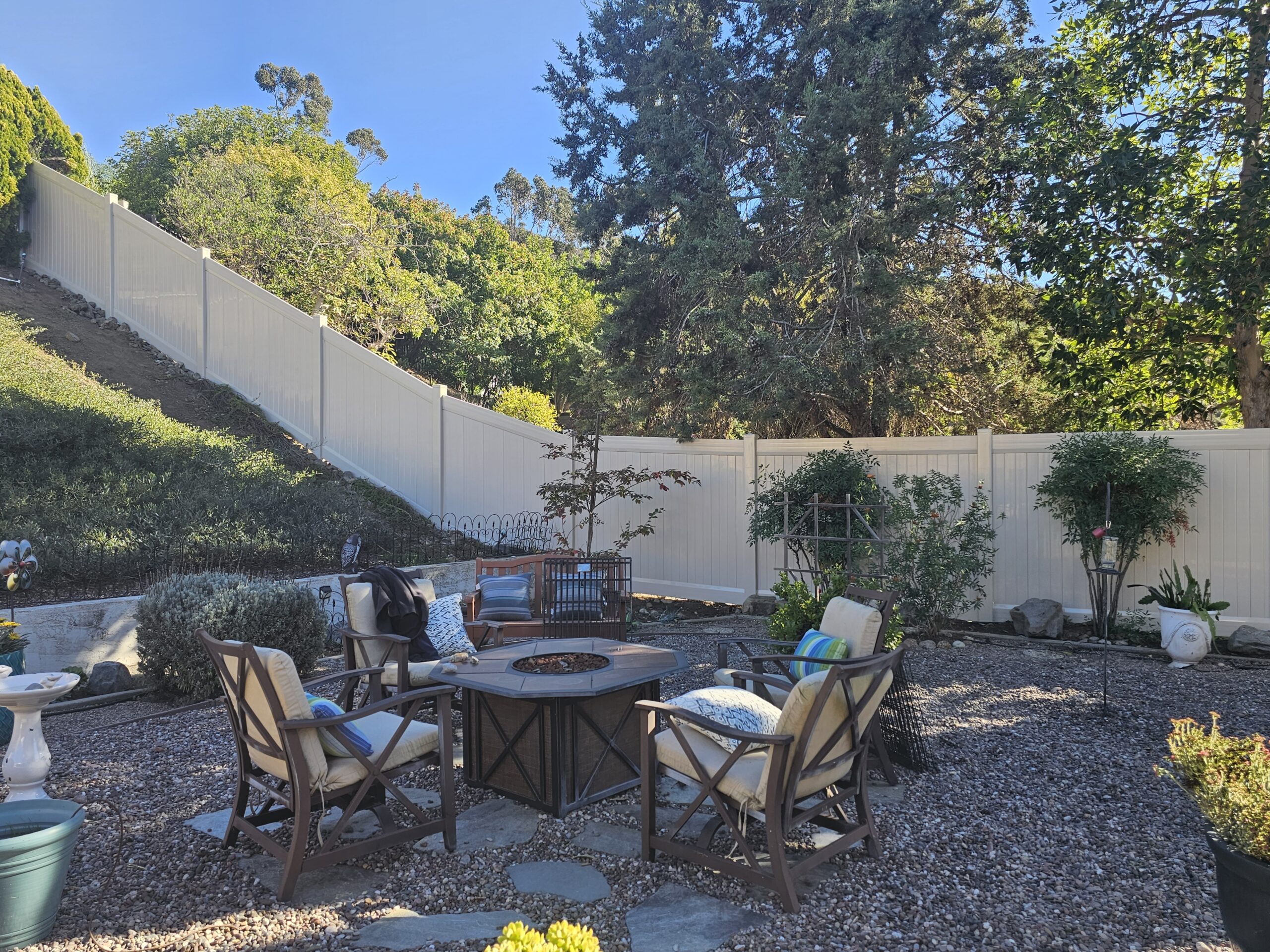 Tall tan vinyl fence up a hill in Ramona CA